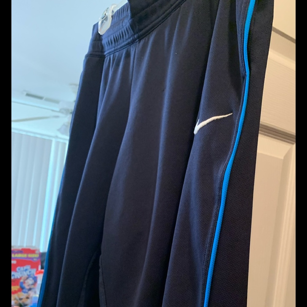 Nike dri-fit capris with royal blue striping on leg, two front pockets